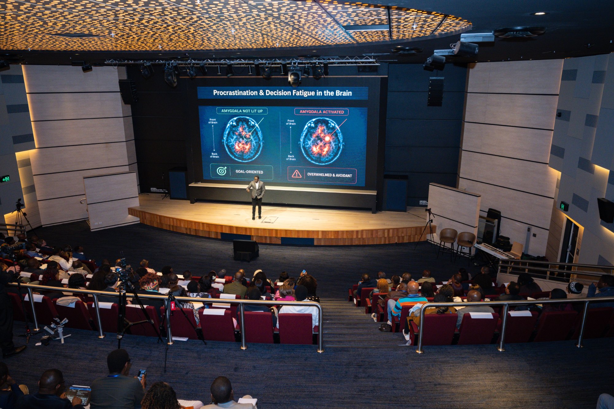 Dr. Niyi Borire presenting to a full hall at TLC Australia 2026